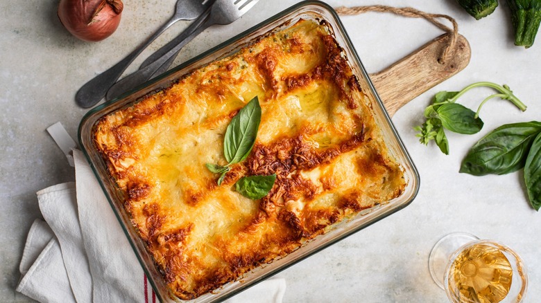 Lasagna on a wooden board and a cloth