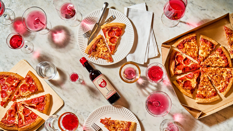 The Pizza Hut wine amidst a sea of pizza and wine glasses