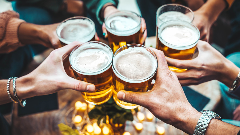 Group of friends toasting glasses of amber beer