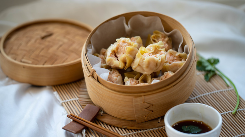 Asian dumplings in a bamboo steamer.