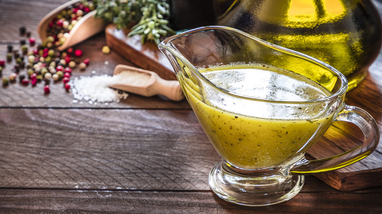 glass gravy boat filled with vinaigrette