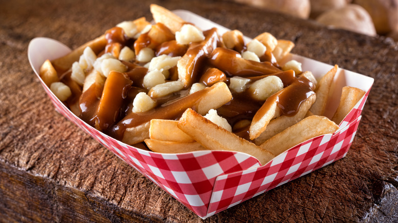Poutine french fries in paper holder