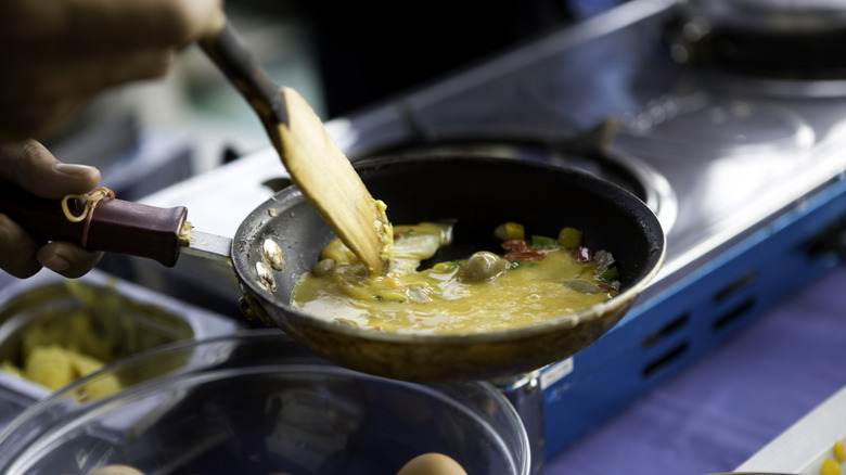 spatula mixing eggs in pan