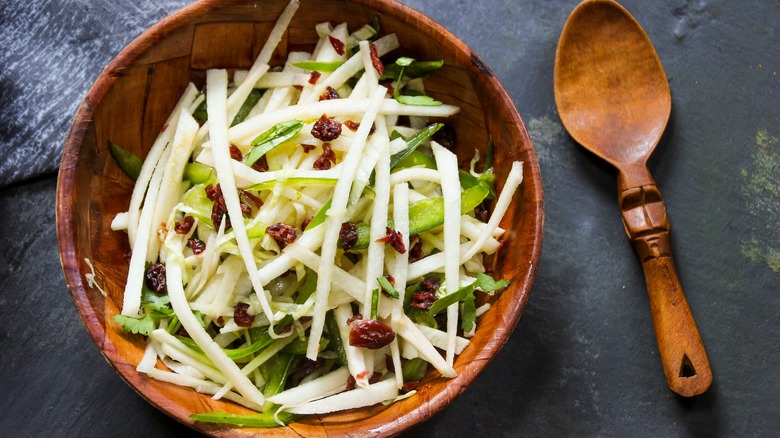 Strips of sliced jicama in brown bowl salad