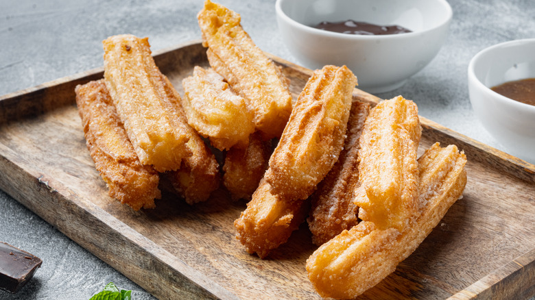 homemade churros on wooden board