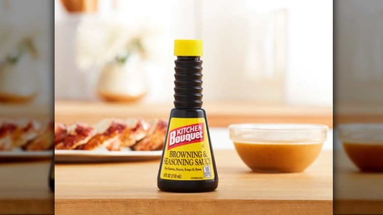 A bottle of kitchen boquet on a wooden table