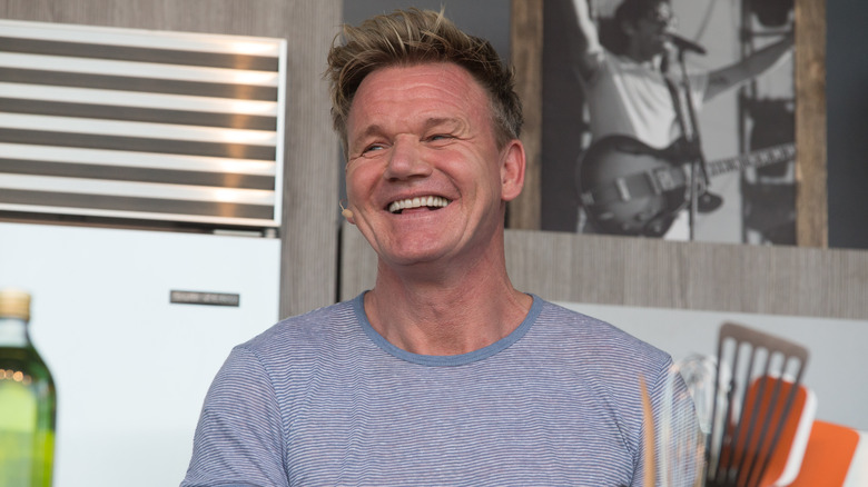 Gordon Ramsay with wide smile looking to the side