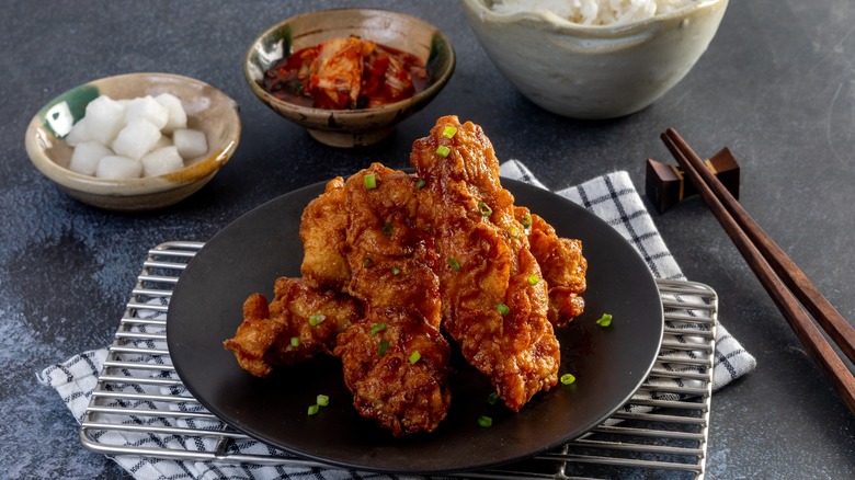 Plate of Korean fried chicken with kimchi and rice