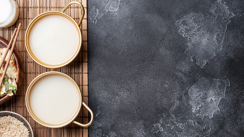 Cups of makgeolli on bamboo mat