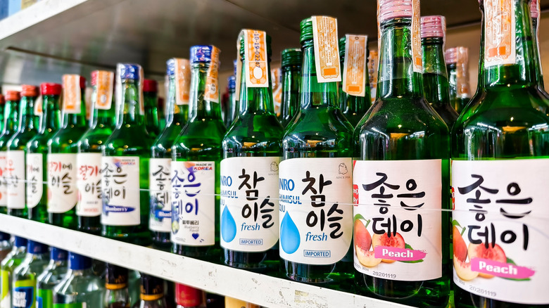 A row of Soju bottles on a store shelf.