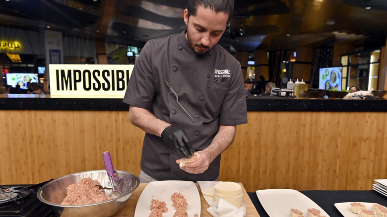 A chef preparing food with Impossible synthetic ingredients