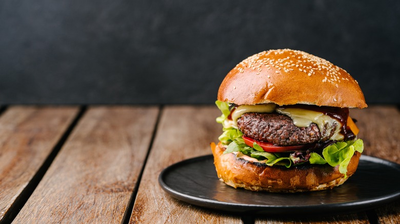 An "impossible" plant-based cheeseburger on a plate