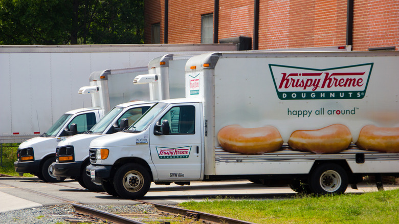 three parked Krispy Kreme trucks