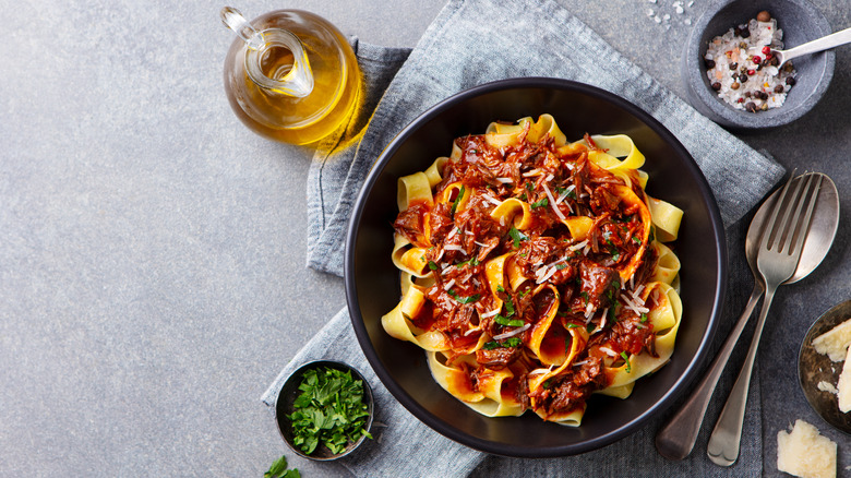 long fettuccine-like noodles in a red ragu sauce