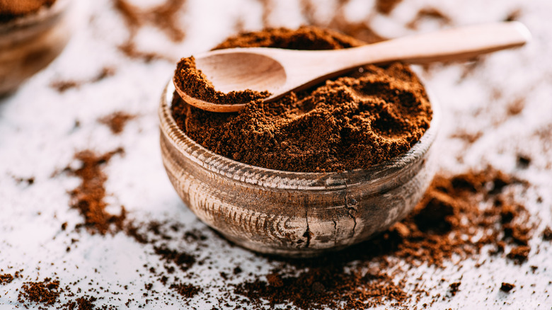 espresso powder in jar with wooden spoon