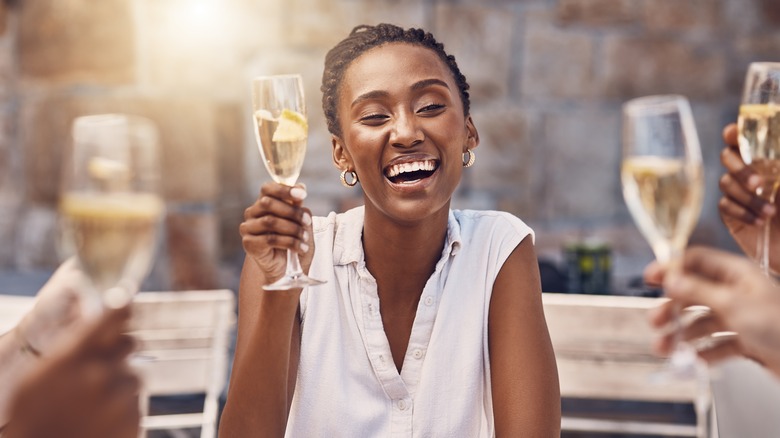 woman smiling with wine glass