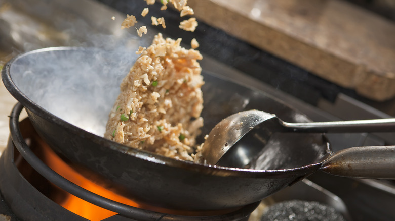 cooking fried rice in a wok