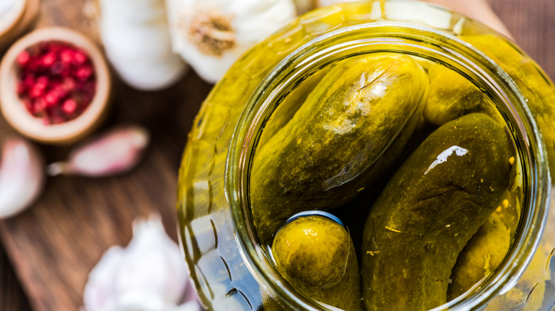 Jar of green pickles in brine