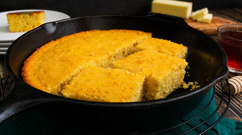 Cast iron with cornbread and butter in the background