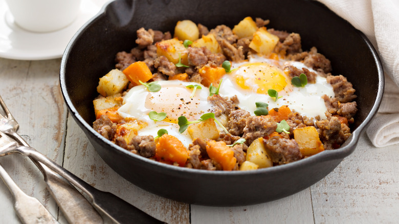 Skillet with hash and fried eggs