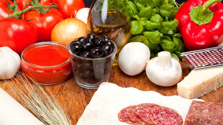 Pizza ingredients on wood surface