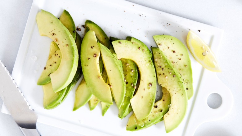 Sliced avocado on cutting board