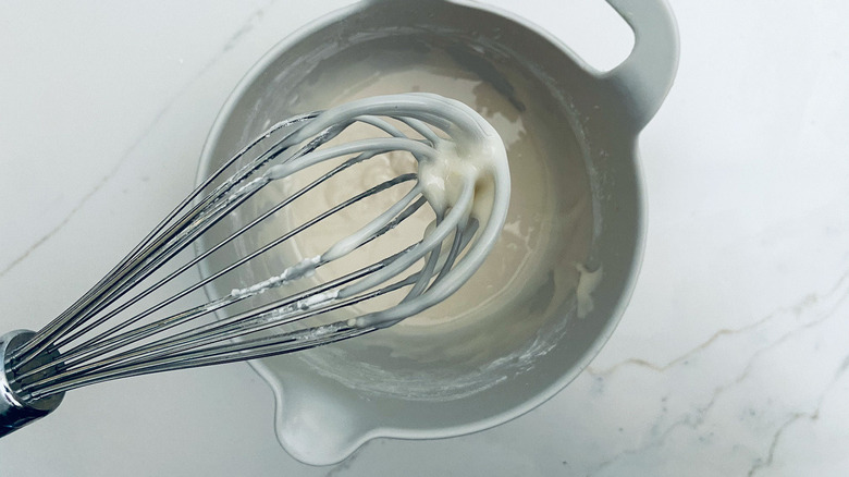 white icing on whisk