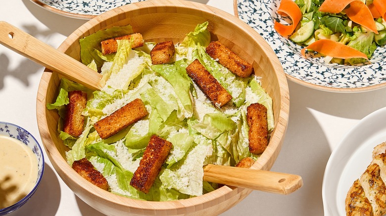 Classic Caesar salad in wooden bowl