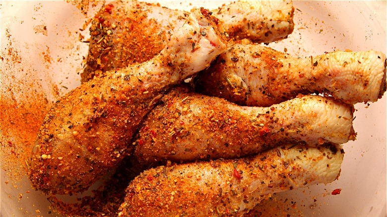 Raw dry rubbed chicken drumsticks 