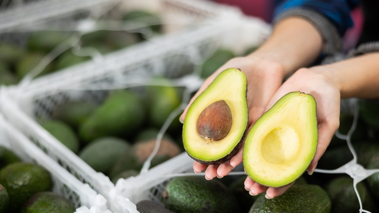 Two halves of pitted avocado.