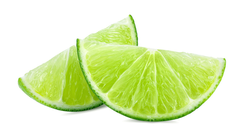 Lime wedges on white background