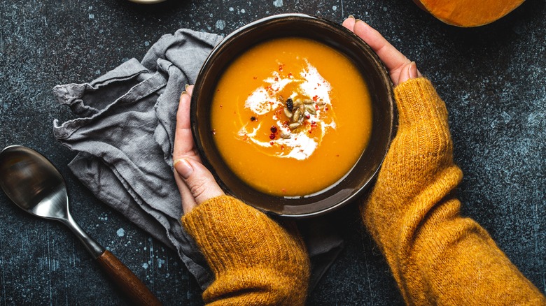 Bowl of squash bisque with squash seeds