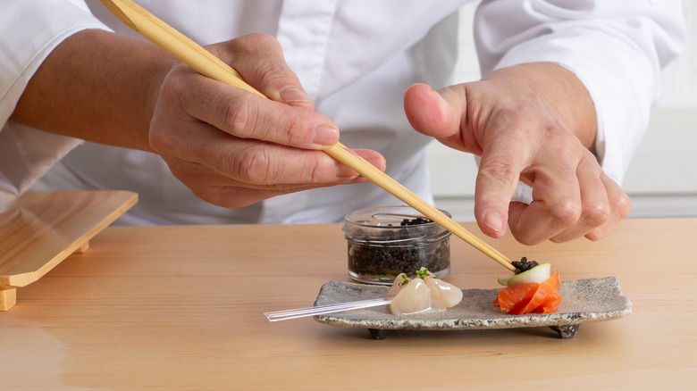 chef placing caviar on sushi