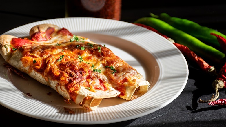 Cooked burritos on white plate 