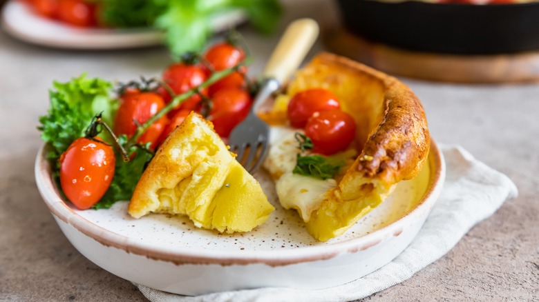 Slice of Dutch baby with tomatoes