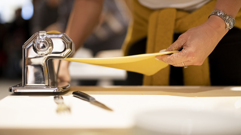 Person using a pasta maker