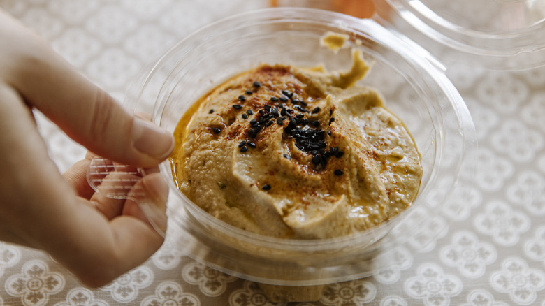container of store-bought hummus