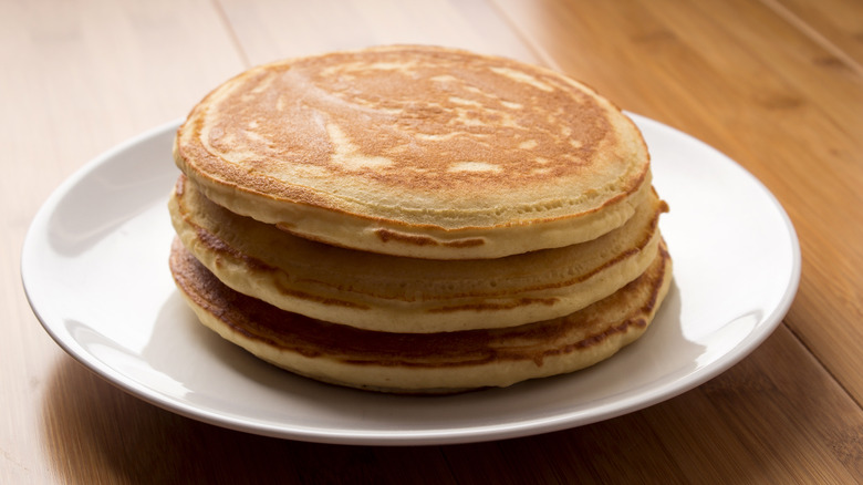 Stack of pancakes on a white plate