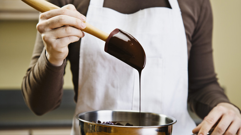 Dripping melted chocolate into pot