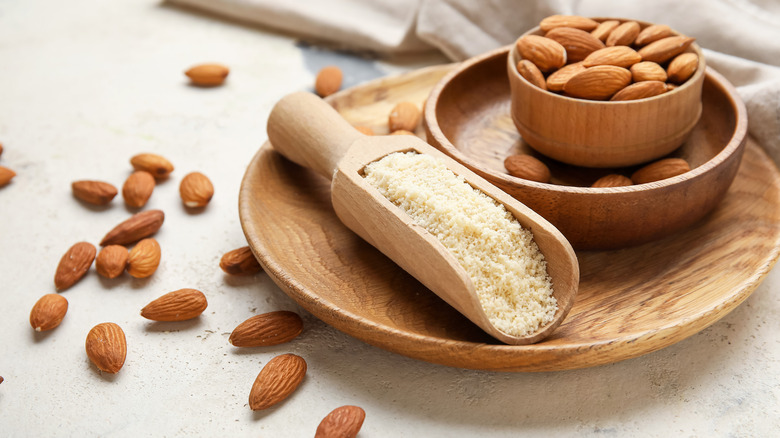 Wooden bowl of almonds and almond flour scoop