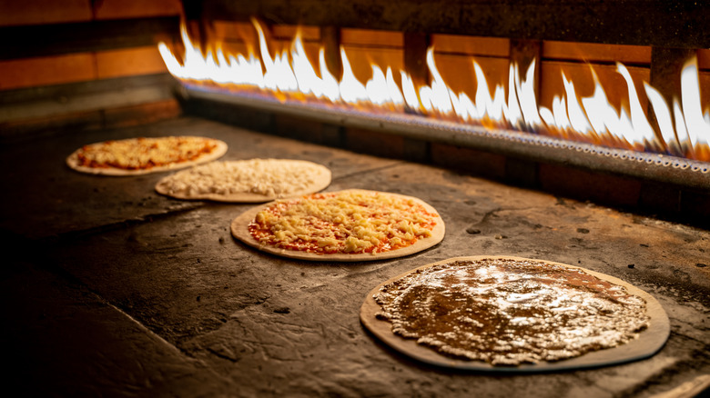 Manakish with various toppings baking in oven