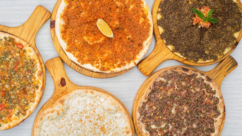 Different versions of manakish atop pizza boards 