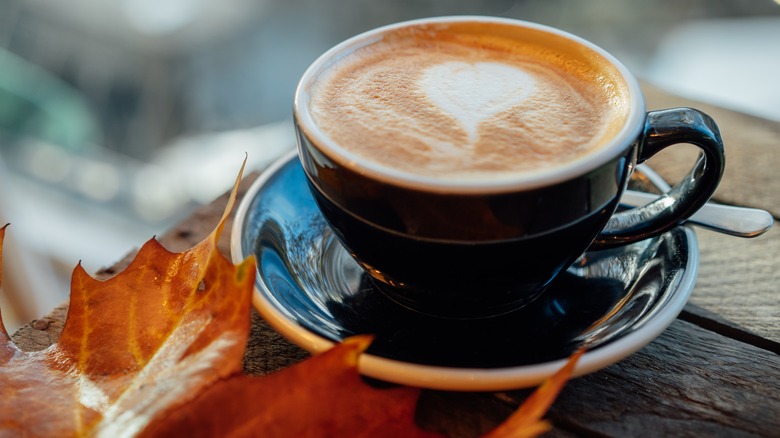 maple leaf and coffee in mug