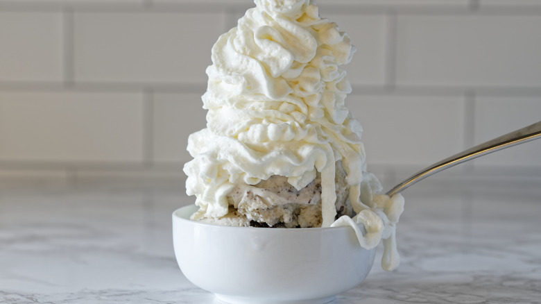 Ice cream sundae with lots of whipped cream