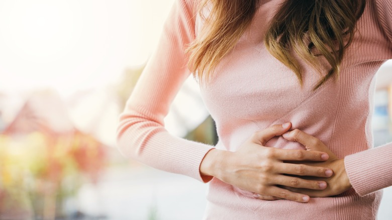 Woman holding stomach