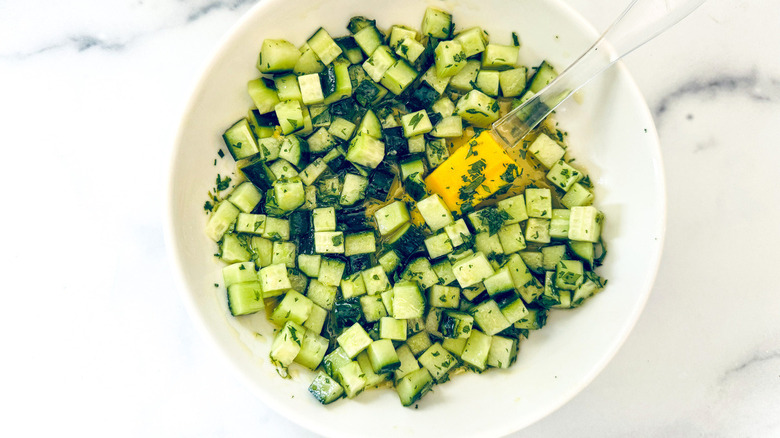 chopped cucumbers in white bowl