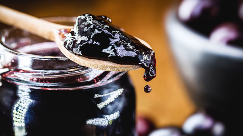 Jelly on spoon on jar