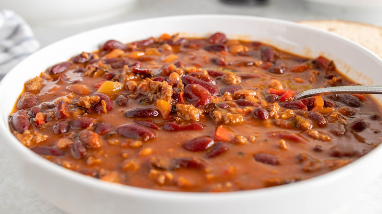 bowl of chili with spoon resting inside