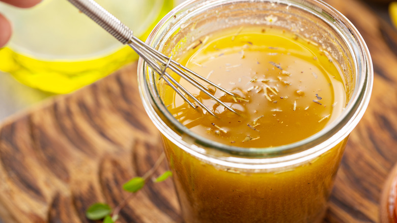 A glass jar full of salad dressing