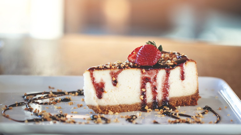 Cheesecake slice with strawberries, nuts